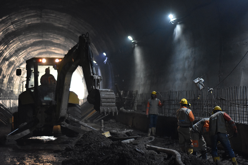 A backhoe loader has been used to prepare the tunnel bed for paving - image courtesy of ANI
